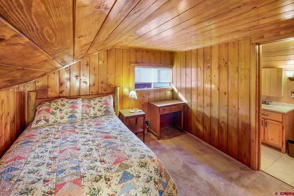 a bed room with a bed and a chair