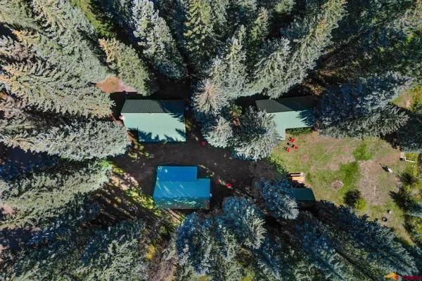 an aerial view of a house with a yard