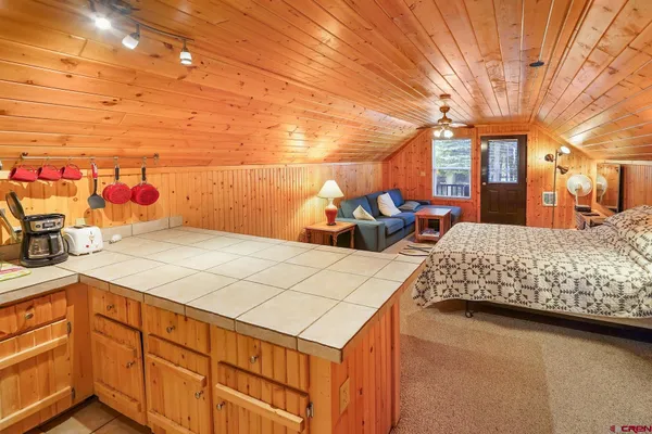 a bedroom with a bed and a night stand