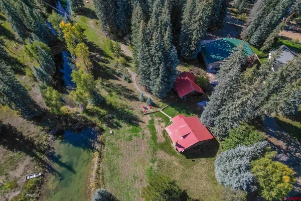 an aerial view of a house with a yard