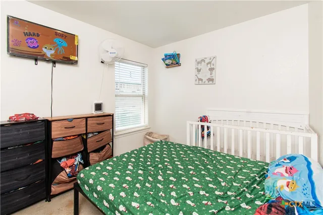 a bedroom with a bed and a dresser in it