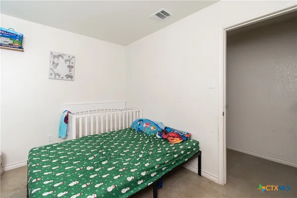 a bedroom with a bed and a table