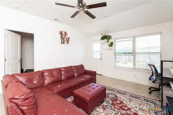 a living room with furniture rug and window