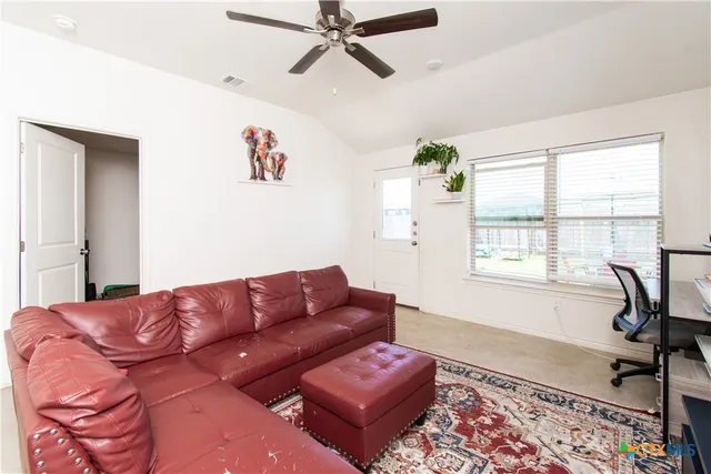 a living room with furniture rug and window