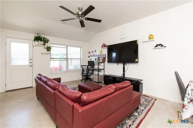 a living room with furniture and a flat screen tv
