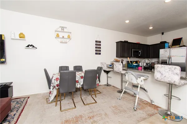 a workspace with furniture and kitchen view