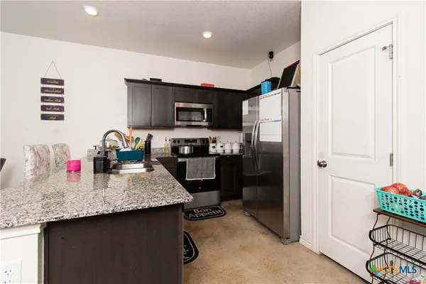 a kitchen with refrigerator and microwave