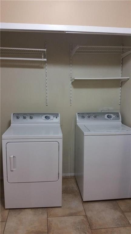 5550 Spring Valley Road, Unit H15 Dallas, TX 75254 - Photo 8 of 9 a utility room with dryer and washer