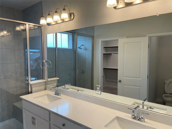 a bathroom with a sink double vanity and a mirror
