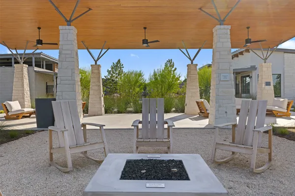 a view of a patio with table and chairs and potted plants
