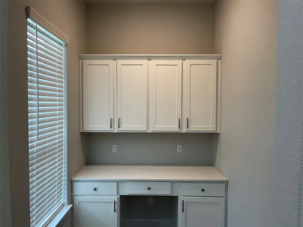 a view of cabinets and window