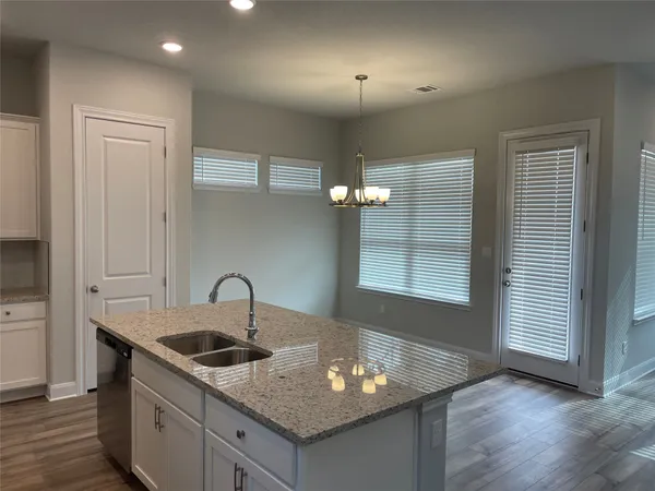 a kitchen with sink and mirror