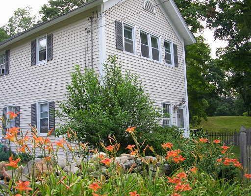 230 Baker Road Roxbury, CT 06783 - Photo 1 of 1 a house that has a lot of flowers in it