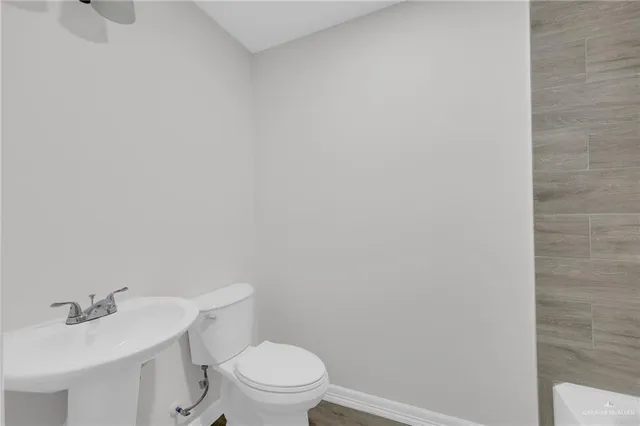 a white toilet sitting next to a white sink