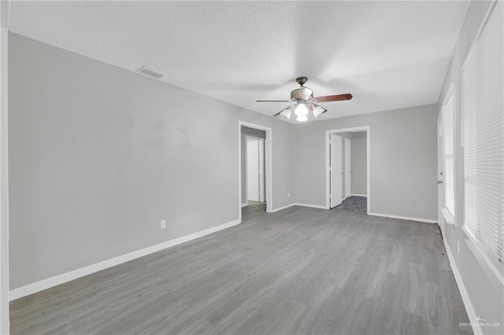 4913 South 26th Street McAllen, TX 78503 - Photo 6 of 15 wooden floor in an empty room with a window