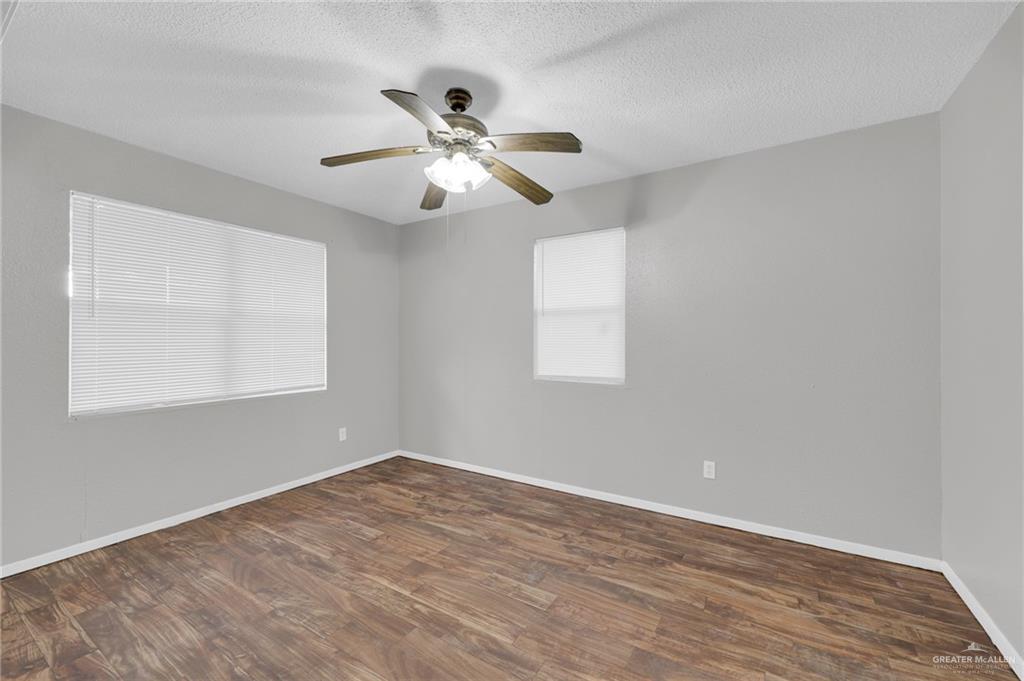 4913 South 26th Street McAllen, TX 78503 - Photo 7 of 15 a view of an empty room with wooden floor and a window