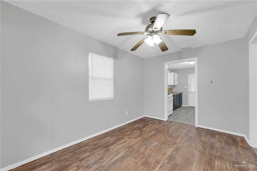 4913 South 26th Street McAllen, TX 78503 - Photo 8 of 15 wooden floor in an empty room with a window