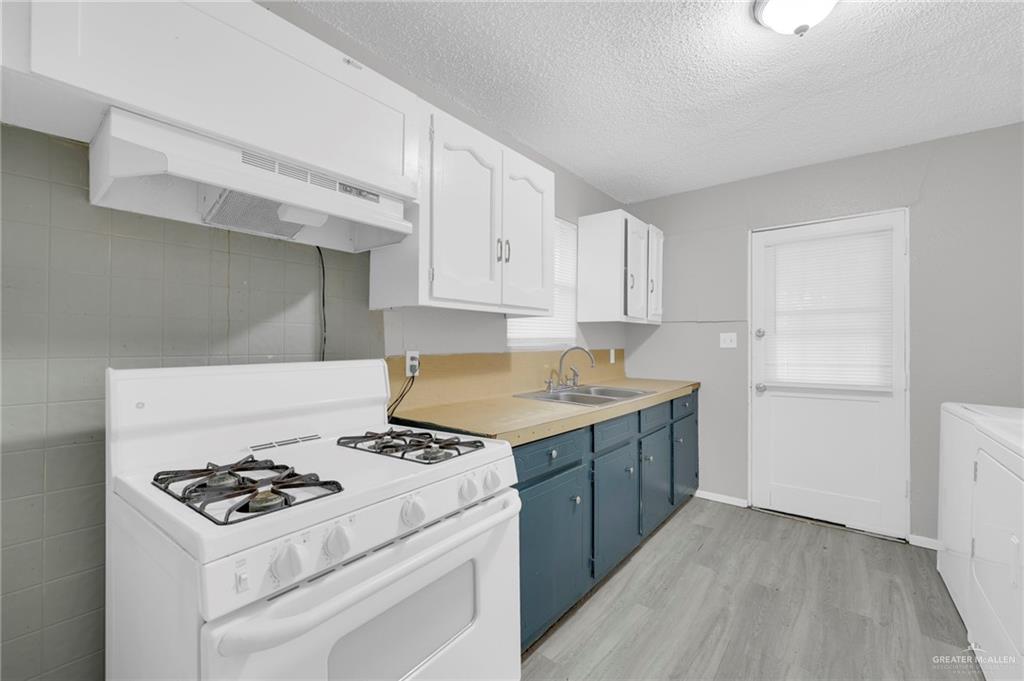 4913 South 26th Street McAllen, TX 78503 - Photo 9 of 15 a kitchen with a stove and a sink