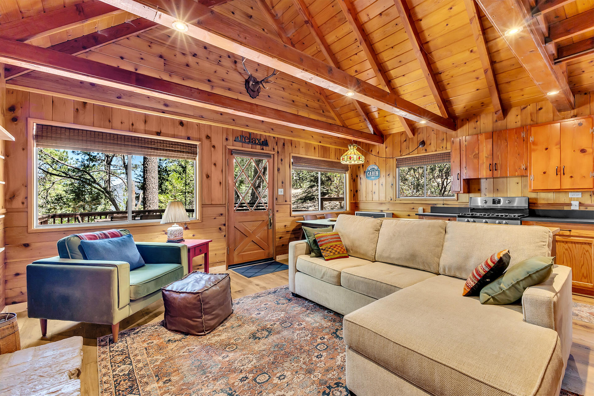 52646 Chickadee Lane Idyllwild, CA 92549 - Photo 23 of 73 a living room with furniture and a floor to ceiling window