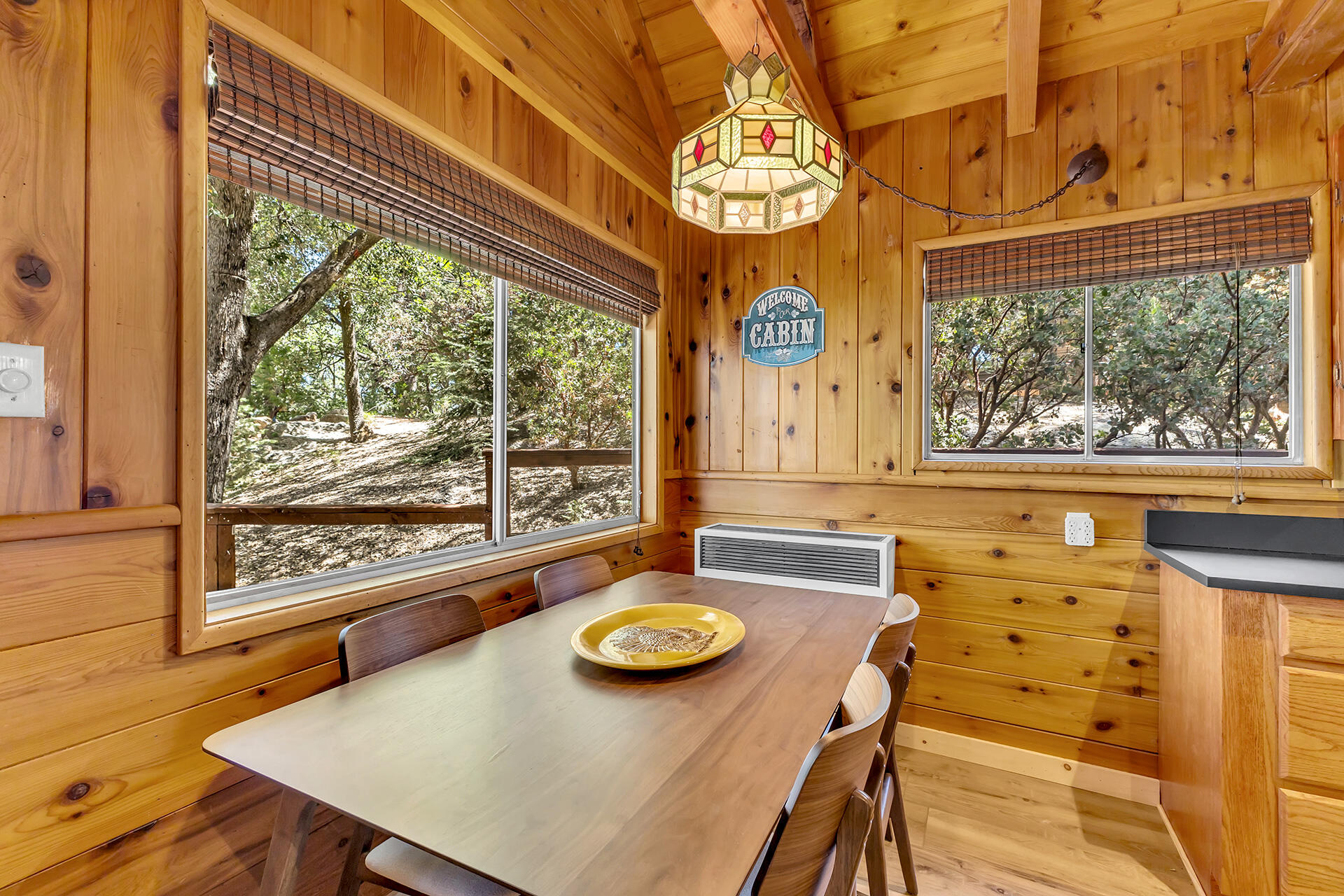 52646 Chickadee Lane Idyllwild, CA 92549 - Photo 24 of 73 a view of a dining room with furniture a chandelier and large windows
