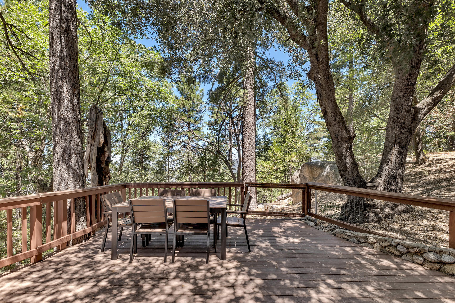 52646 Chickadee Lane Idyllwild, CA 92549 - Photo 47 of 73 a view of a patio with table and chairs and wooden fence