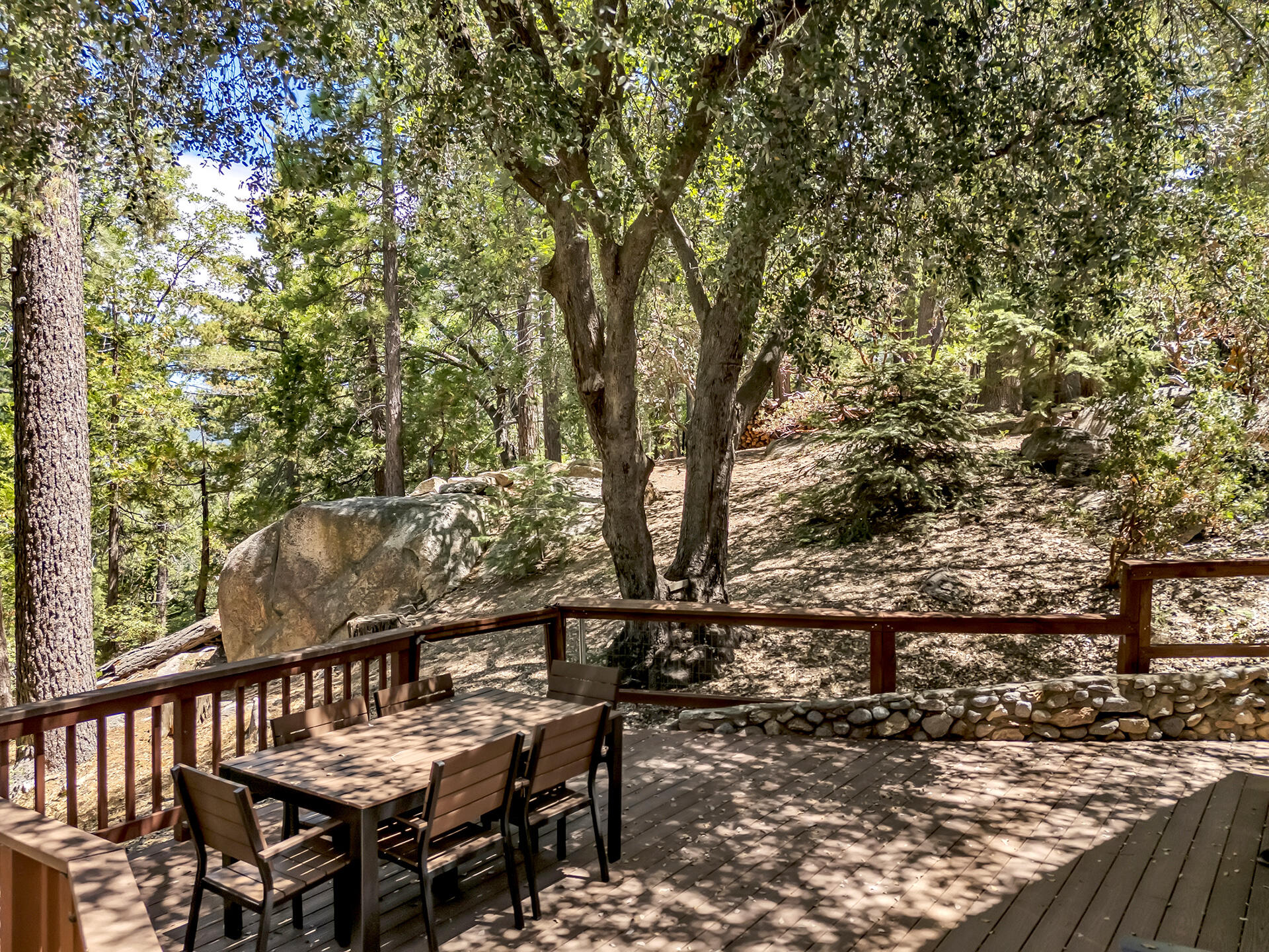 52646 Chickadee Lane Idyllwild, CA 92549 - Photo 62 of 73 a view of a balcony with wooden floor and outdoor seating