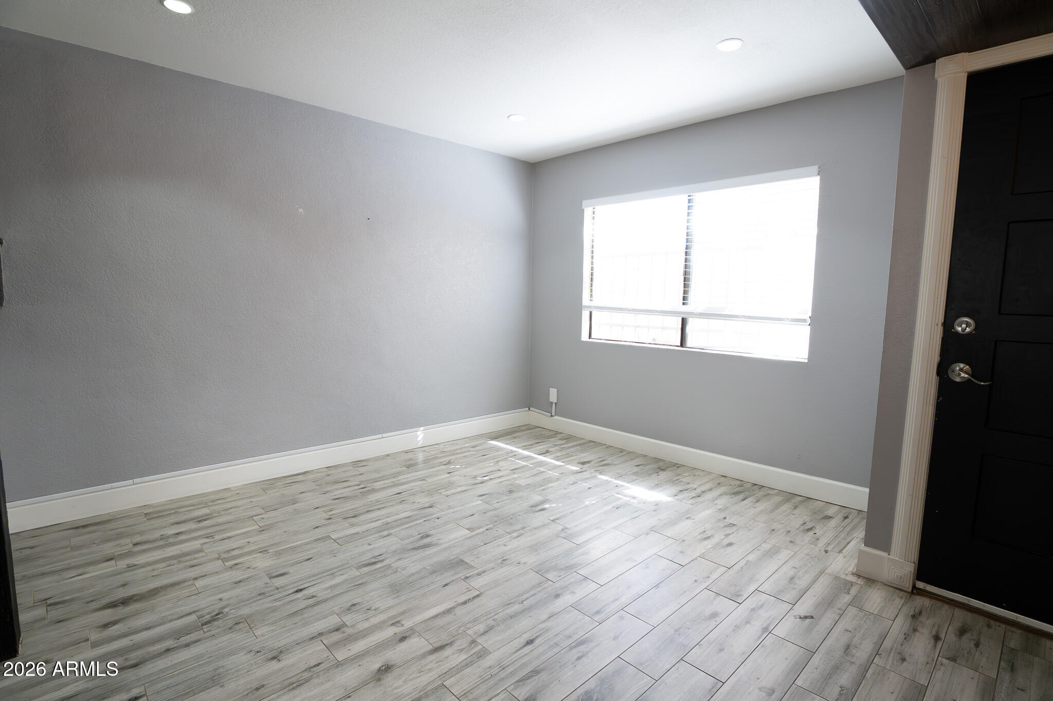 5100 North Miller Road, Unit 3 Scottsdale, AZ 85250 - Photo 5 of 31 an empty room with wooden floor and windows