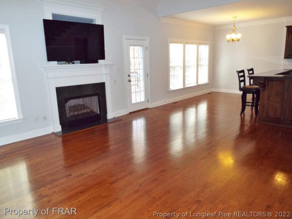 239 Falling Water Road Spring Lake, NC 28390 - Photo 12 of 36 a view of a livingroom with furniture wooden floor fire place and windows