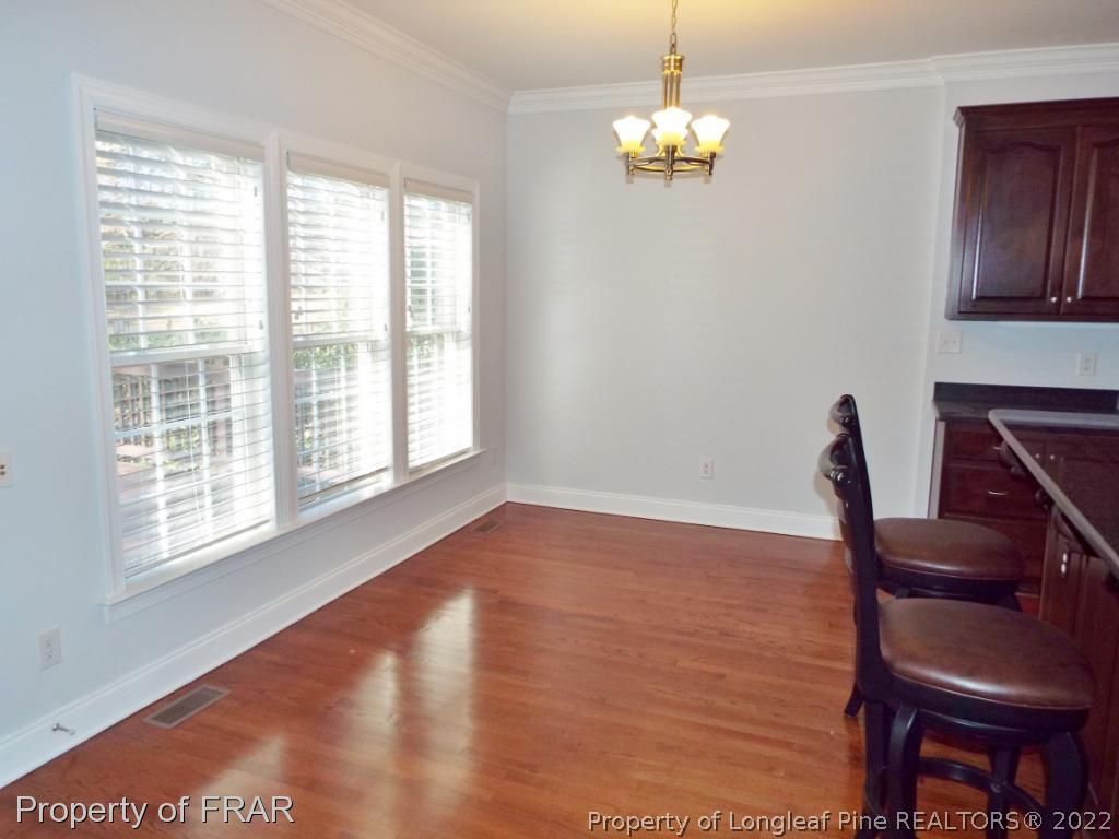 239 Falling Water Road Spring Lake, NC 28390 - Photo 14 of 36 a view of an empty room with wooden floor and a window