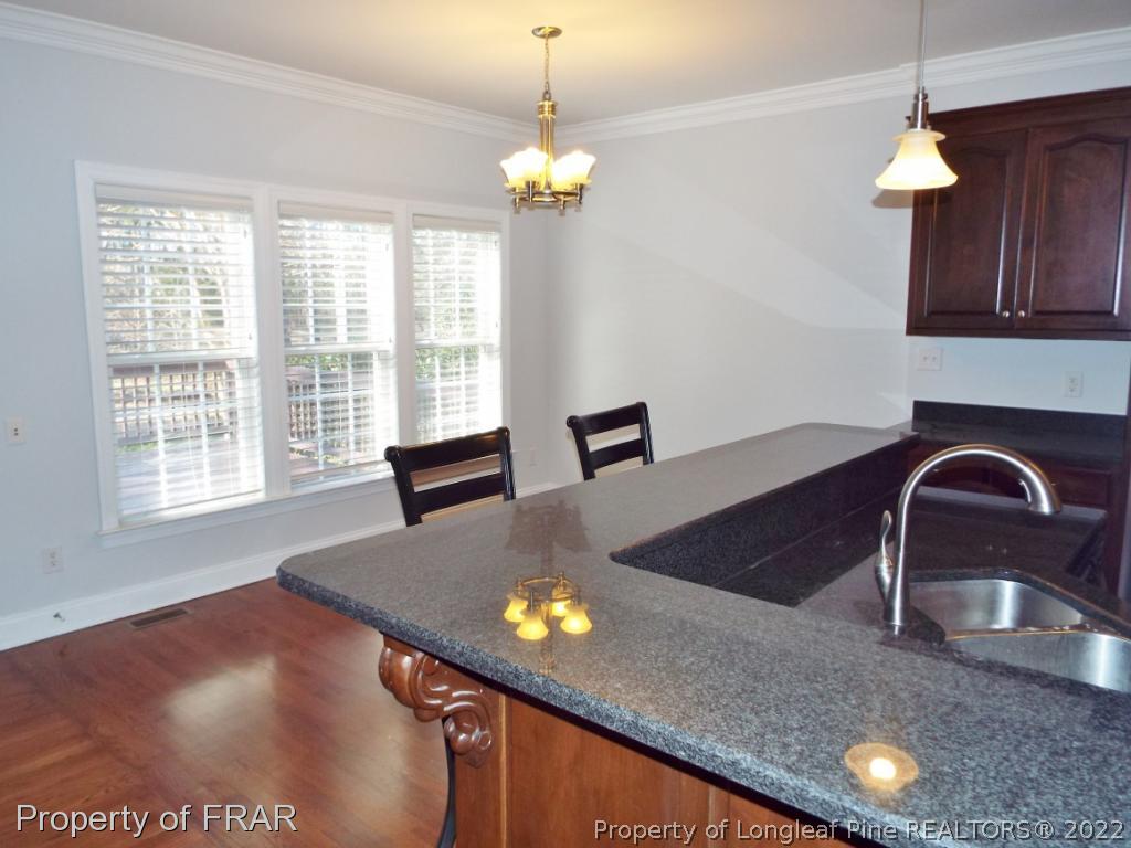239 Falling Water Road Spring Lake, NC 28390 - Photo 15 of 36 a view of a kitchen with kitchen island a sink appliances and a counter top space