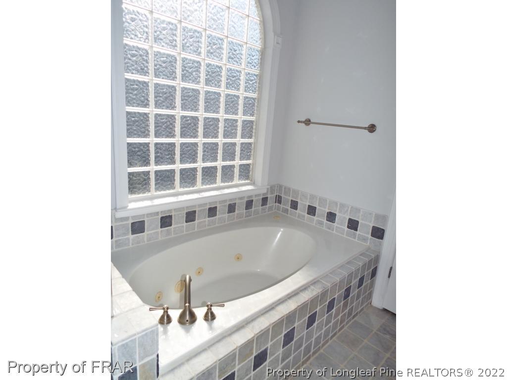239 Falling Water Road Spring Lake, NC 28390 - Photo 26 of 36 a bath tub sitting in a bathroom next to a window