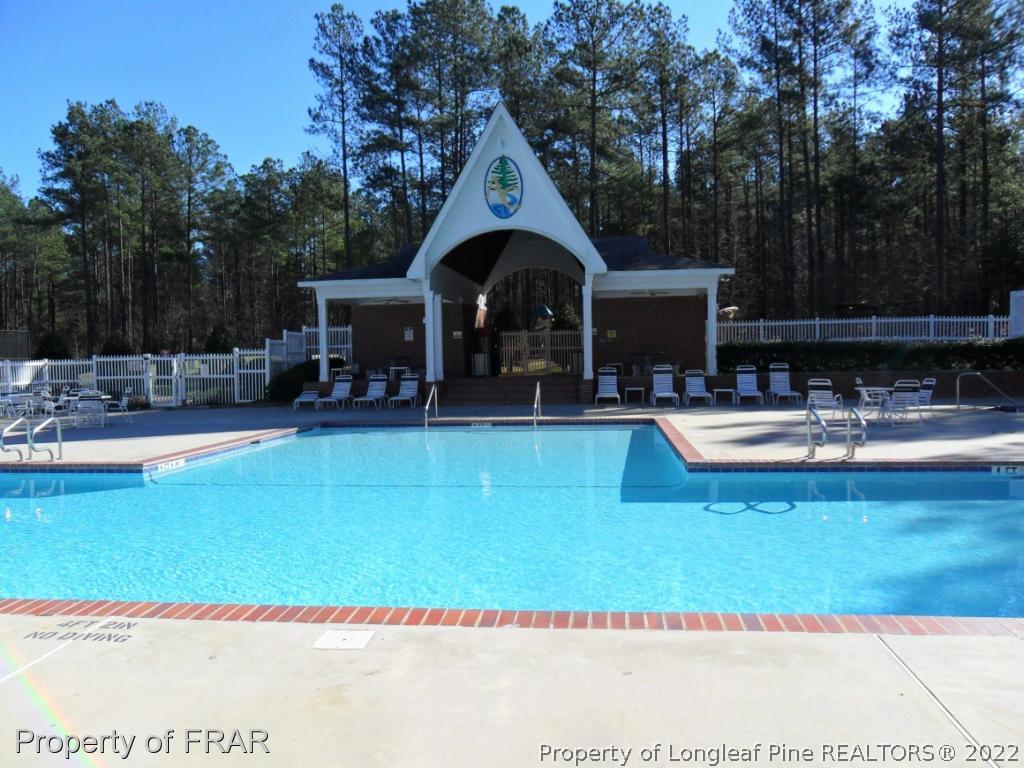 239 Falling Water Road Spring Lake, NC 28390 - Photo 35 of 36 a swimming pool with outdoor seating and yard