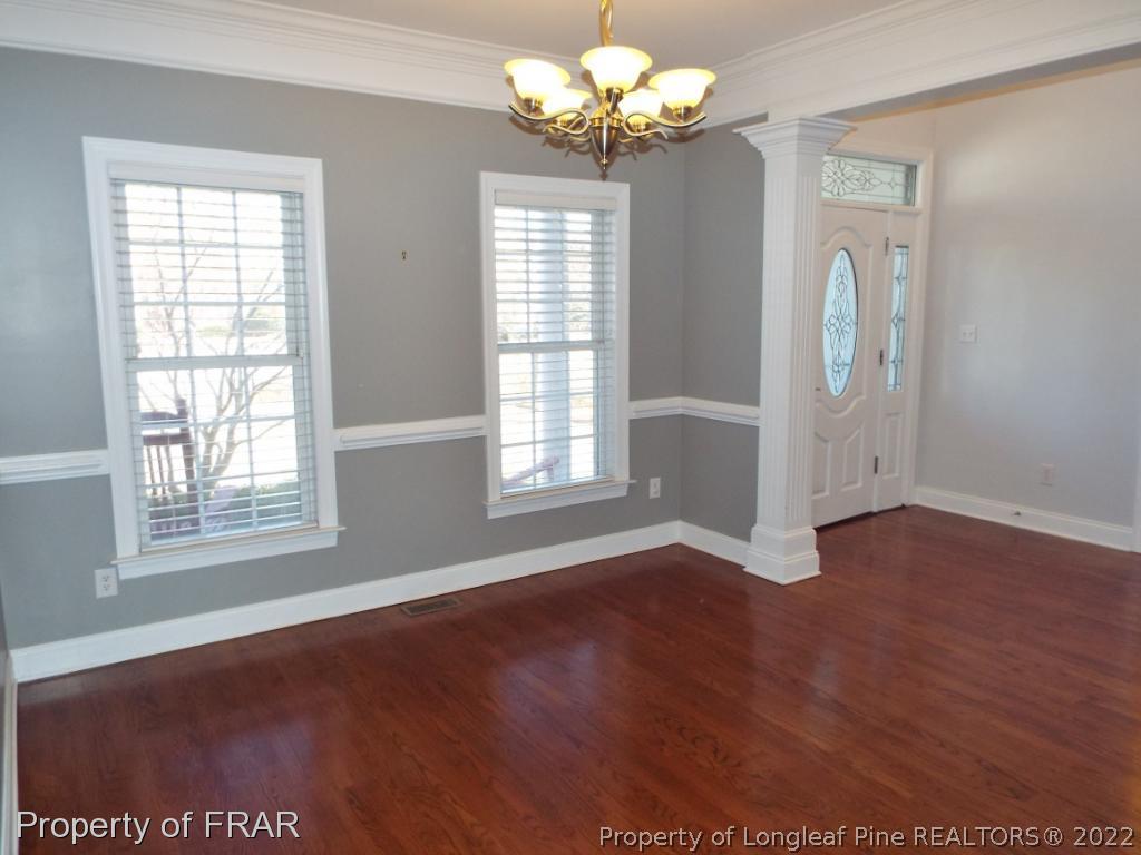 239 Falling Water Road Spring Lake, NC 28390 - Photo 9 of 36 a view of an empty room with wooden floor and a window