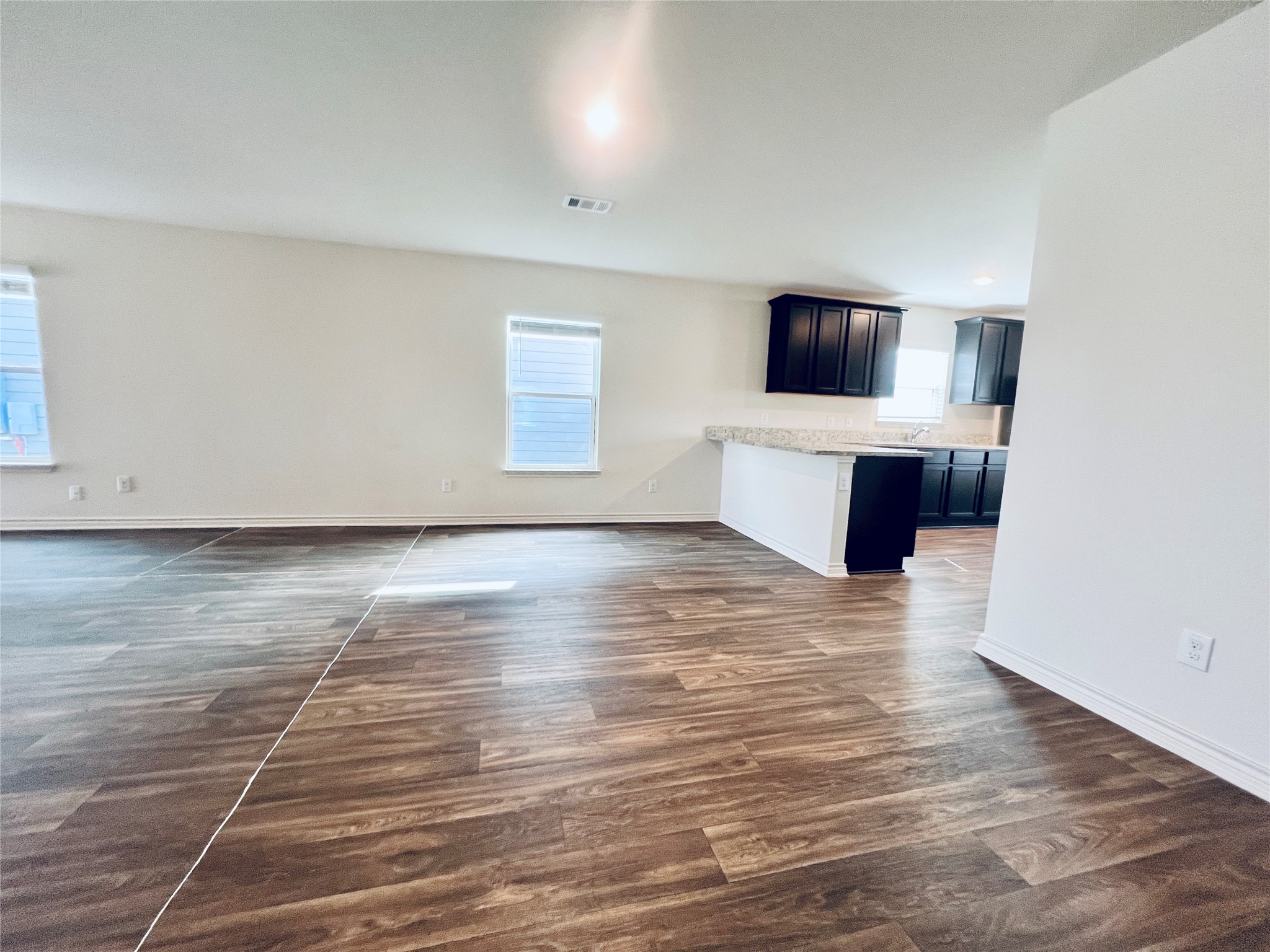 520 Locksley Cove Jarrell, TX 76537 - Photo 27 of 27 An open floorplan seamlessly connects a well-lit living area to a modern kitchen.