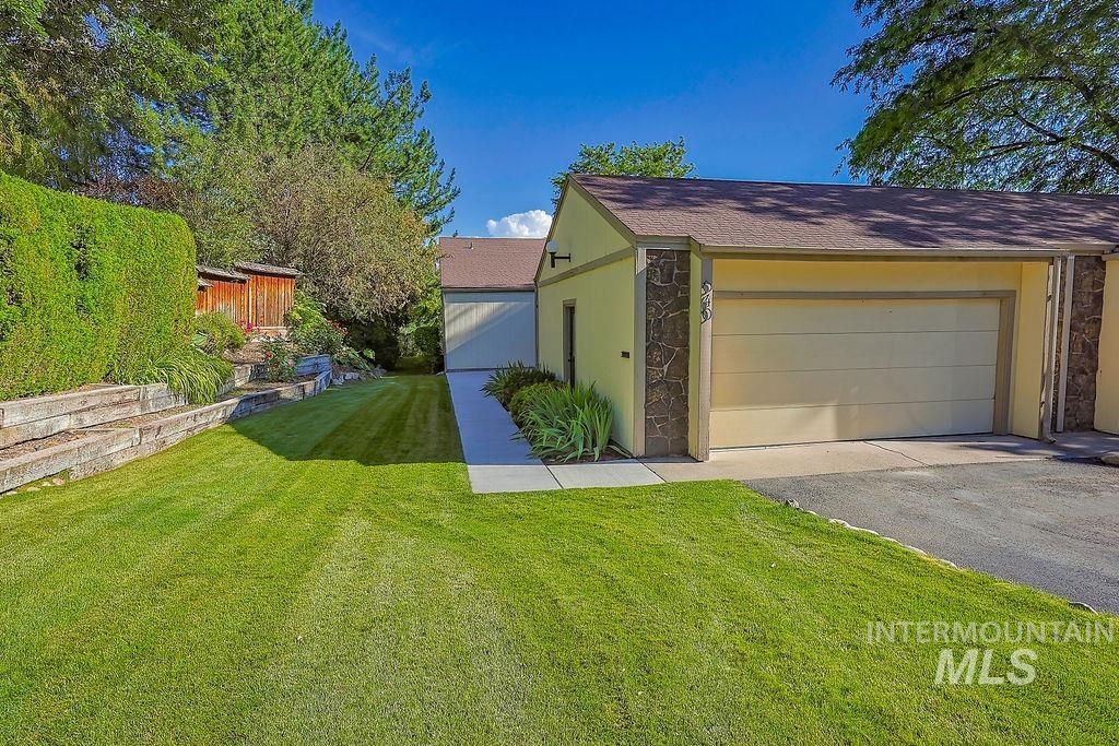 640 Morrison Street Twin Falls, ID 83301 - Photo 2 of 30 Attached garage featuring stone veneer accents and a paved driveway