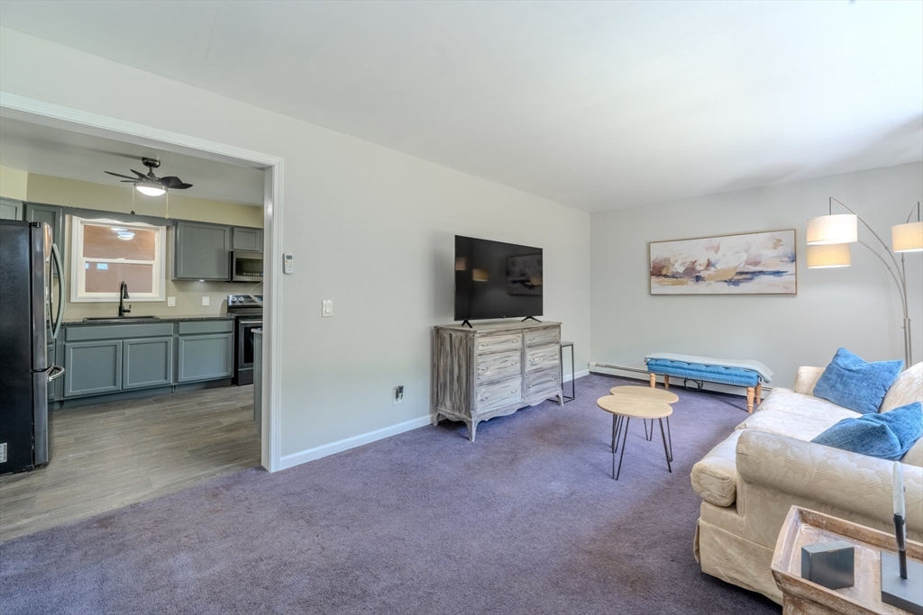 66 Great Road Shirley, MA 01464 - Photo 14 of 40 a view of a livingroom with furniture and a flat screen tv