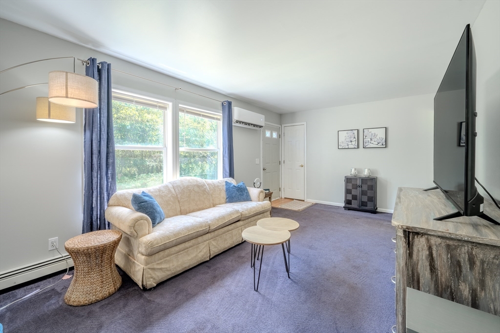 66 Great Road Shirley, MA 01464 - Photo 16 of 40 a living room with furniture and a flat screen tv