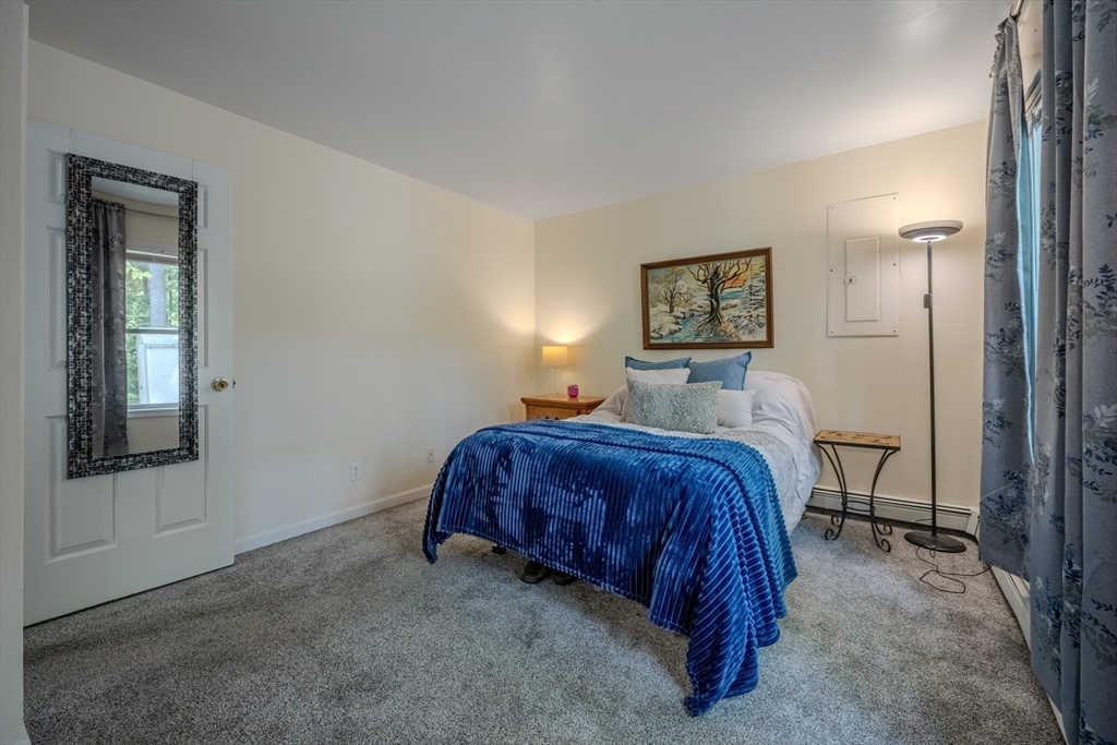 66 Great Road Shirley, MA 01464 - Photo 22 of 40 a spacious bedroom with a bed and a window