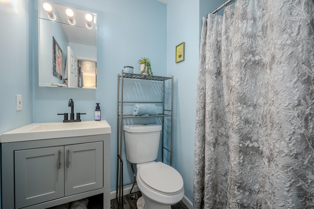 66 Great Road Shirley, MA 01464 - Photo 24 of 40 a bathroom with a granite countertop toilet sink and mirror