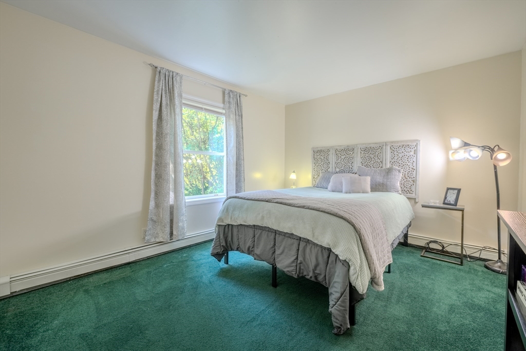 66 Great Road Shirley, MA 01464 - Photo 25 of 40 a bed sitting in a bedroom next to a window