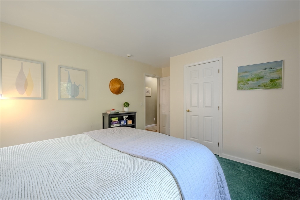 66 Great Road Shirley, MA 01464 - Photo 27 of 40 a bedroom with a bed and a lamp