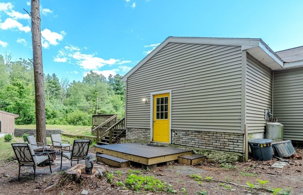 66 Great Road Shirley, MA 01464 - Photo 32 of 40 a view of a patio with chairs and table in the backyard