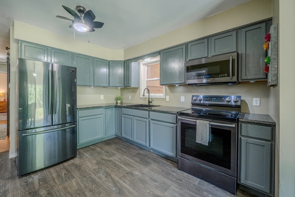 66 Great Road Shirley, MA 01464 - Photo 8 of 40 a kitchen with stainless steel appliances granite countertop a stove a refrigerator and a microwave