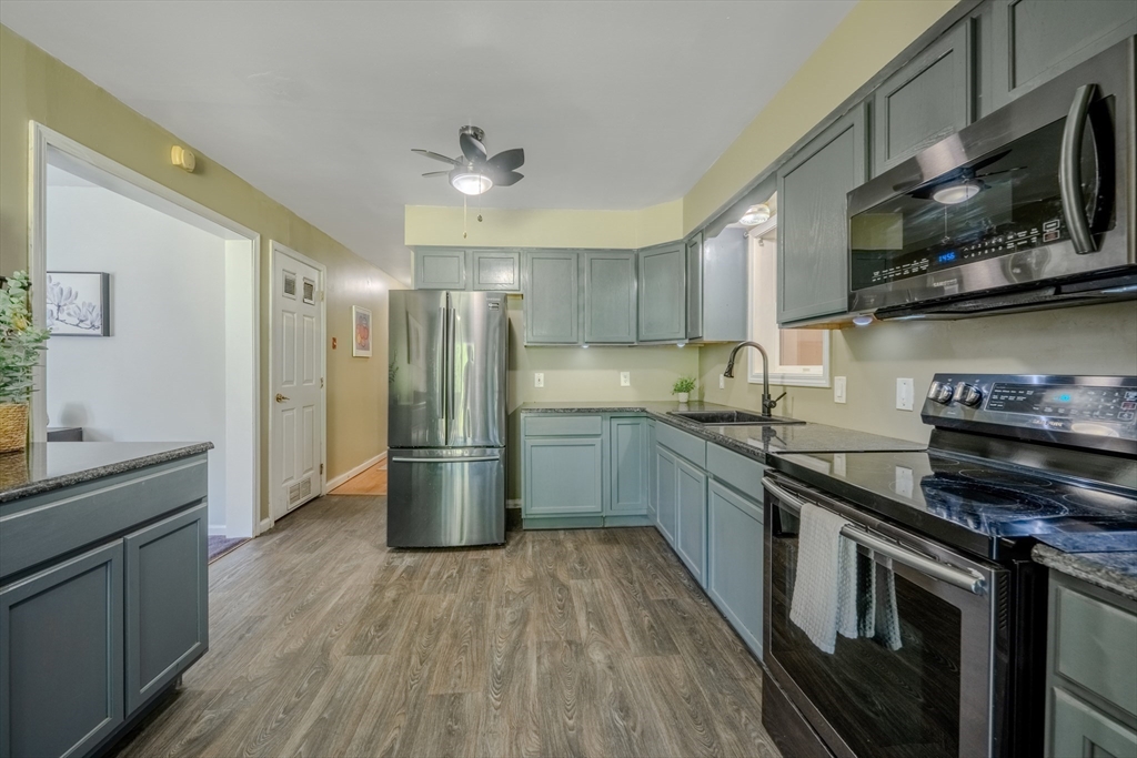66 Great Road Shirley, MA 01464 - Photo 9 of 40 a kitchen with stainless steel appliances a stove a sink and a refrigerator