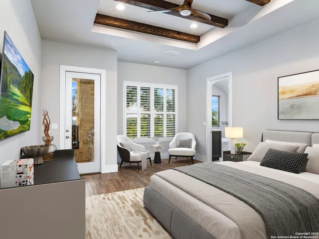 a bedroom with a bed and a painting on the wall