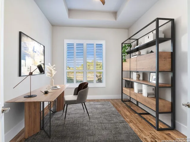 a large kitchen with stainless steel appliances kitchen island granite countertop a refrigerator a stove and white cabinets with wooden floor