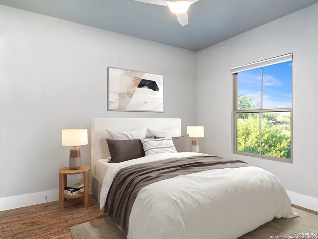 a kitchen with stainless steel appliances a stove a sink a refrigerator and a wooden floor