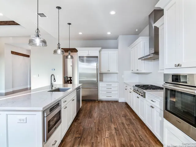 a bathroom with a granite countertop sink a toilet and a mirror