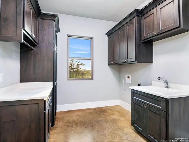 a view of a patio with couches table and chairs with plants and garden