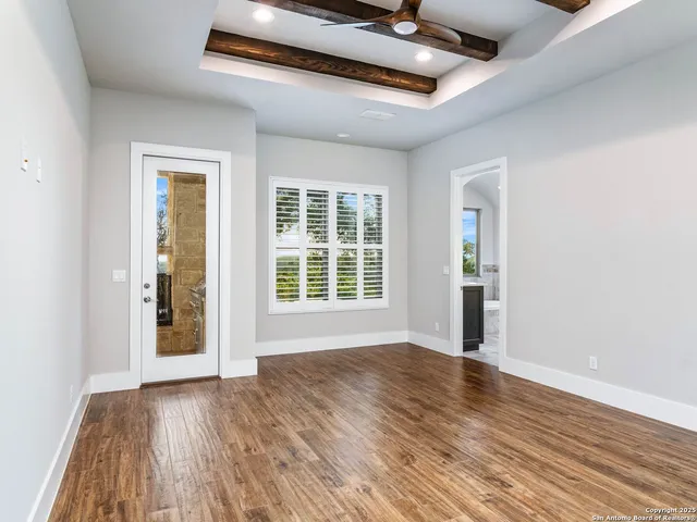 a view of a patio with a table and chairs under an umbrella